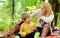 Having snack during hike. Happy childhood. Mom and kid boy relaxing while hiking forest. Family picnic. Mother pretty