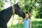 Having the truest friend. Adorable horse owner with her pet. Young woman with horse on summer landscape. Pretty girl at