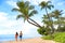 Hawaii beach vacation couple walking - people lifestyle. Kaanapali beach, Maui, Hawaii, USA. Two person, man, woman