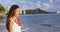 Hawaii - Beach woman smiling laughing having fun on Hawaii Waikiki wearing Lei