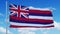 Hawaii flag on a flagpole waving in the wind, blue sky background. 4K