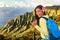 Hawaii hiker girl tourist doing shaka hawaiian hand sign at Na pali lookout in Kauai, Hawaii. Travel Asian woman