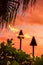 Hawaii luau party Maui fire tiki torches with flames burning against sunset sky clouds at night. Hawaiian culture travel