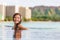 Hawaii luxury hotel vacation Asian woman relaxing in resort swimming pool overlooking Waikiki beach in Honolulu, Hawaii