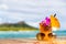 Hawaii mai tai cocktail drink on waikiki beach bar with flower, pineapple and sunglasses. View of the ocean and diamond
