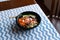 Hawaii poke bowl with salmon, rice, surimi, avocado, tobiko, carrot and seaweed