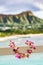 Hawaii travel background. Hawaiian lei flower necklace at holiday resort for luau Hula party with Waikiki beach Honolulu mountain