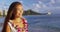 Hawaii travel beach vacation - woman smiling happy wearing Hawaiian flower Lei