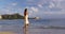 Hawaii travel beach vacation - woman walking wearing hawaiian flower Lei