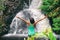 Hawaii travel nature waterfall woman hiker at Canyon Trail Waipoo Falls in Waimea, Kauai island, USA. Freedom happy girl with open