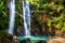 Hawaii woman tourist excited by waterfall