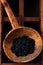 Hawaiian Black lava sea salt in rustic wooden spoon