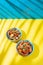 Hawaiian pinapple chicken in blue bowls on yellow blue background. Trendy sunlight effect