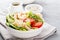 Hawaiian poke bowl with shrimps, rice and vegetables, healthy Buddha bowl with prawns, rice, avocado, cucumber, tomato and lettuce