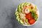 Hawaiian poke bowl with shrimps, rice and vegetables, healthy Buddha bowl with prawns, rice, avocado, cucumber, tomato and lettuce