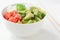 Hawaiian poke bowl with smoked salmon lox, avocado, white rice, cucumber and sesame seeds.