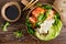 Hawaiian poke coconut bowl with grilled salmon fish, rice and avocado. Healthy food