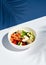 Hawaiian salmon fish poke bowl on white and classic blue background