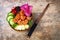 Hawaiian salmon poke bowl with seaweed, watermelon radish, cucumber, pineapple and sesame seeds. Copy space