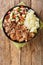 Hawaiian Style Slow Cooker Kalua Pork served with stewed cabbage and fresh salad closeup in the slate plate. Verticall top view