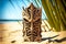 hawaiian totem tiki mask made of wood on beach under palm tree