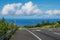 Hawaiin road dips down into the blue ocean