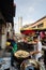 Hawker cook deep fried dough at street in morning market.