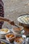 Hawker making tiny shrimp pancake at street food vendor market