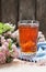 Hawthorn spring floral tea with spring blooming pink branches of haw thorn with flower buds on rustic wooden background