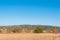 Hay bail truck crossing near dry hay field clear cut path warm color bulgaria rural landscape sun day clear blue sky