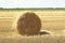 Hay bale. Haystacks harvested on field in summer. Haystack rolls on agriculture field landscape. Agriculture field haystack