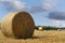 Hay bale and straw in the field. English Rural   landscape.   Wheat yellow golden harvest in summer. Countryside natural landscape