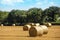 Hay bale and straw in the field. English Rural landscape. Wheat yellow golden harvest in summer. Countryside natural landscape.