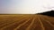 Hay bale tractor. Tractor harvesting hay into bales in field on sunny day.