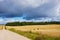 Hay bales. Agriculture field with cloudy sky.