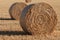 Hay bales in a crop field.