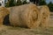 The hay bales are drying in the field.