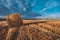 Hay bales on field in autumn weather.