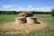 Hay Bales, Green Grass, Trees and Blue Sky