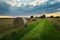 Hay bales next to a dirt path