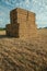 Hay bales piled up on field in a farm