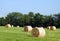 Hay bales scattered to dry in the hot summer sun
