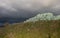 Hay bales under stormy skies