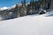 Hay barn on a snowy alpine pasture