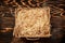 Hay in box on brown wooden pallet with decorative hay inside on a rustic table. top view, space for text