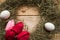 Hay frame, tulips and eggs on wooden background, top view.