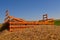 Hay rack partially buried by straw