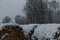 Hay roll covered with forst white snow