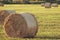 Hay rolled into a bale, sunset and sun illuminates the clearing, fodder for cattle cleaning