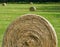 Hay is rolled, wrapped and left to dry in the hot summer sun